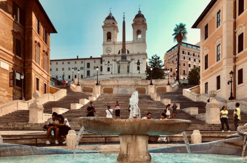 fountain in front of white concrete building during daytime